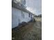 Side view of home with white siding, a wood pile, and some garbage cans at 4805 Barbee Rd, Durham, NC 27713