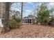 View of the backyard featuring a screened in porch and mature trees at 4812 Stonehill Dr, Raleigh, NC 27609