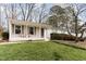 Picture of the home's front exterior, featuring a covered porch with charming chairs and well-kept lawn at 4812 Stonehill Dr, Raleigh, NC 27609