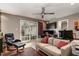 This living room has a ceiling fan, a sliding glass door, and comfortable seating at 4812 Stonehill Dr, Raleigh, NC 27609