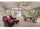 Spacious screened porch featuring comfortable seating and a table, ideal for outdoor entertaining at 4812 Stonehill Dr, Raleigh, NC 27609