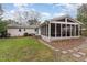 Picture of the screened in porch with neutral furniture and a stepping stone walkway at 4812 Stonehill Dr, Raleigh, NC 27609
