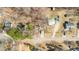 An aerial view showing the neighborhood and surrounding wooded area with bare trees in winter at 4901 North Pointe, Sanford, NC 27332