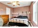 Comfortable bedroom with wood-look floors, ceiling fan, and a metal frame bed at 4901 North Pointe, Sanford, NC 27332