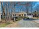 Charming one-story home featuring a cozy porch, a gravel driveway, and a convenient carport on a sunny day at 4901 North Pointe, Sanford, NC 27332