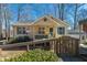 Close up of a charming one-story home featuring a cozy porch with a decorated entryway and a gravel driveway at 4901 North Pointe, Sanford, NC 27332