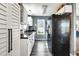 Galley kitchen featuring white cabinets, black appliances, granite countertops, and wood style flooring at 4901 North Pointe, Sanford, NC 27332