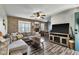 Open concept living room with brick accent wall, modern furnishings, and a view into the dining area at 4901 North Pointe, Sanford, NC 27332