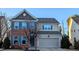 Charming two-story home featuring a brick facade, attached garage, and well-manicured landscaping at 508 Stapleford Ln, Fuquay Varina, NC 27526