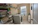 Functional laundry room featuring modern appliances, storage shelves, and natural light from a window at 508 Stapleford Ln, Fuquay Varina, NC 27526