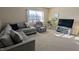 Cozy living room with comfortable seating, a ceiling fan, and natural light at 508 Stapleford Ln, Fuquay Varina, NC 27526