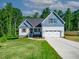 Charming home with a two-car garage, light blue shingle accents, and a well-manicured lawn at 5389 Salem Woods Dr # 12, Graham, NC 27253