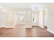Bright living room featuring wood floors, white trim, coffered ceilings, and plenty of natural light at 5389 Salem Woods Dr # 12, Graham, NC 27253
