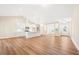 Open-concept living area featuring wood floors, neutral paint, and a seamless flow to the kitchen at 5389 Salem Woods Dr # 12, Graham, NC 27253