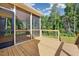 Screened-in porch with wood floors and railings, overlooking a lush backyard at 5389 Salem Woods Dr # 12, Graham, NC 27253