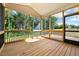 Screened-in porch with wood floors and railings, overlooking a lush backyard at 5389 Salem Woods Dr # 12, Graham, NC 27253