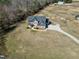 Aerial view showcasing the home's spacious lot, long driveway, three-car garage and serene surroundings at 5439 Cokesbury Rd, Fuquay Varina, NC 27526