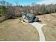 An aerial view shows the home on a large lot with a long driveway and an attached three-car garage at 5439 Cokesbury Rd, Fuquay Varina, NC 27526