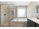 Bathroom featuring a glass shower and soaking tub under a window at 5439 Cokesbury Rd, Fuquay Varina, NC 27526