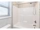 Bathroom featuring white tiled shower-tub and chrome shower head at 5439 Cokesbury Rd, Fuquay Varina, NC 27526