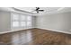 Large bedroom featuring a trey ceiling, hardwood floors, and ample natural light at 5439 Cokesbury Rd, Fuquay Varina, NC 27526