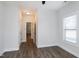 This bedroom boasts a ceiling fan, neutral walls, and dark wood floors at 5439 Cokesbury Rd, Fuquay Varina, NC 27526