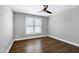 A cozy bedroom with a ceiling fan and rich hardwood floors at 5439 Cokesbury Rd, Fuquay Varina, NC 27526
