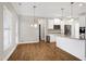 Dining room features hardwood floors, modern lighting, and easy access to the kitchen at 5439 Cokesbury Rd, Fuquay Varina, NC 27526