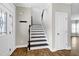 Foyer boasts hardwood floors, white door, and staircase to the second floor at 5439 Cokesbury Rd, Fuquay Varina, NC 27526