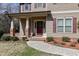 Welcoming front entrance features a decorative door, a covered porch, and landscaped garden beds at 5439 Cokesbury Rd, Fuquay Varina, NC 27526