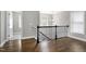 Hallway featuring hardwood floors, natural light, and staircase at 5439 Cokesbury Rd, Fuquay Varina, NC 27526