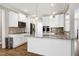 Modern kitchen with white cabinets, granite countertops, and stainless steel appliances at 5439 Cokesbury Rd, Fuquay Varina, NC 27526