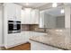 Modern kitchen features granite counters, a tiled backsplash and white cabinets at 5439 Cokesbury Rd, Fuquay Varina, NC 27526