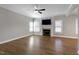 Spacious living room with fireplace, ceiling fan, and large windows, perfect for relaxation and entertaining at 5439 Cokesbury Rd, Fuquay Varina, NC 27526
