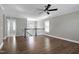 Bright living room with ceiling fan, hardwood floors, and staircase at 5439 Cokesbury Rd, Fuquay Varina, NC 27526