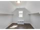 Walk-in closet with rods, shelves, and wood flooring at 5439 Cokesbury Rd, Fuquay Varina, NC 27526