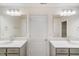 Bright bathroom features double vanities with white countertops and large mirrors at 6800 Franklin Heights Rd, Cary, NC 27518