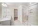 Bright bathroom featuring a single vanity, glass-enclosed shower, and a walk-in closet at 6800 Franklin Heights Rd, Cary, NC 27518