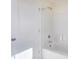 Bright bathroom featuring a shower and tub combination with white tile and a shower head at 6800 Franklin Heights Rd, Cary, NC 27518