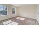 Bright bedroom featuring large windows allowing ample natural light and views of new construction outside at 6800 Franklin Heights Rd, Cary, NC 27518