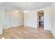 Dining room leads to the kitchen; features wood flooring and modern lighting fixture at 6800 Franklin Heights Rd, Cary, NC 27518