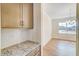 Butlers pantry between the kitchen and dining room with wood-look floors and natural light at 6800 Franklin Heights Rd, Cary, NC 27518