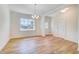 Bright dining room featuring wood flooring, chandelier, and plenty of natural light at 6800 Franklin Heights Rd, Cary, NC 27518