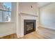 Modern fireplace with white mantel and black surround, complemented by hardwood flooring at 6800 Franklin Heights Rd, Cary, NC 27518
