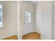 Bright foyer featuring a glass-paneled front door, white trim, and light hardwood floors at 6800 Franklin Heights Rd, Cary, NC 27518