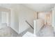 Upstairs hallway with neutral carpet and open view to rooms and bathroom at 6800 Franklin Heights Rd, Cary, NC 27518
