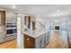 Open floor plan with an island kitchen that connects to the living room and gas fireplace at 6800 Franklin Heights Rd, Cary, NC 27518