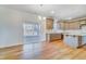 Eat-in kitchen with a sliding glass door to the screened in porch and wood-look floors at 6800 Franklin Heights Rd, Cary, NC 27518