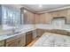 Updated kitchen with stainless steel appliances, light countertops, and a large window over the sink at 6800 Franklin Heights Rd, Cary, NC 27518