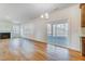 Open-concept living area with a fireplace, large windows, and a sliding glass door to the screened porch at 6800 Franklin Heights Rd, Cary, NC 27518